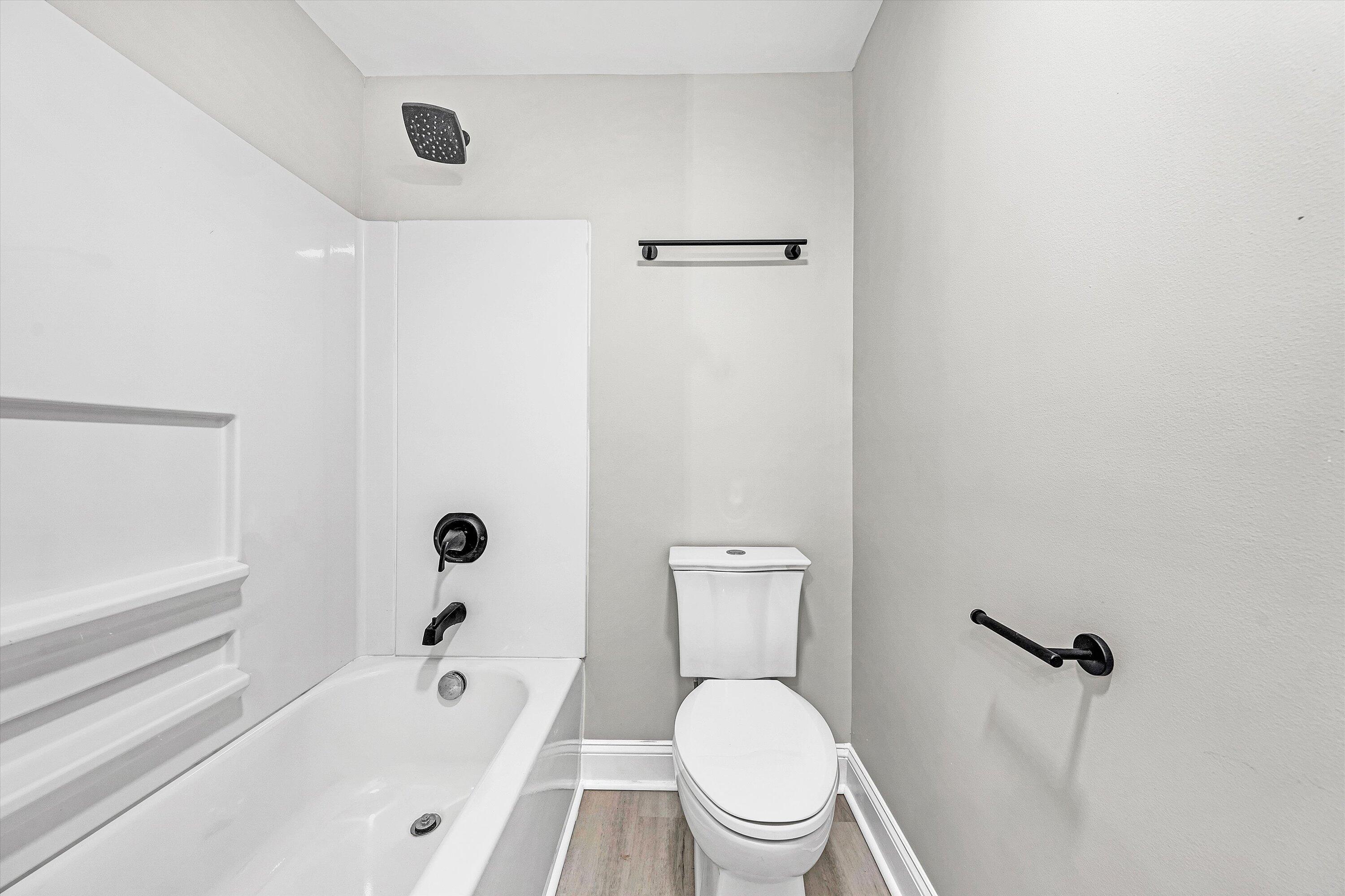 809 Ward Street Northwest Roanoke, VA 24017 - Photo 11 of 15 a white toilet sitting next to a bath tub