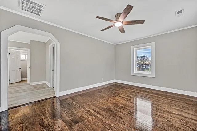 a view of a hallway with wooden floor