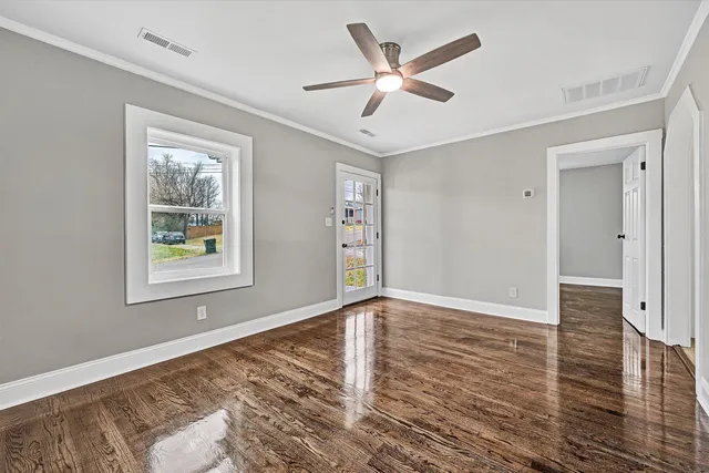 wooden floor in an empty room with a window