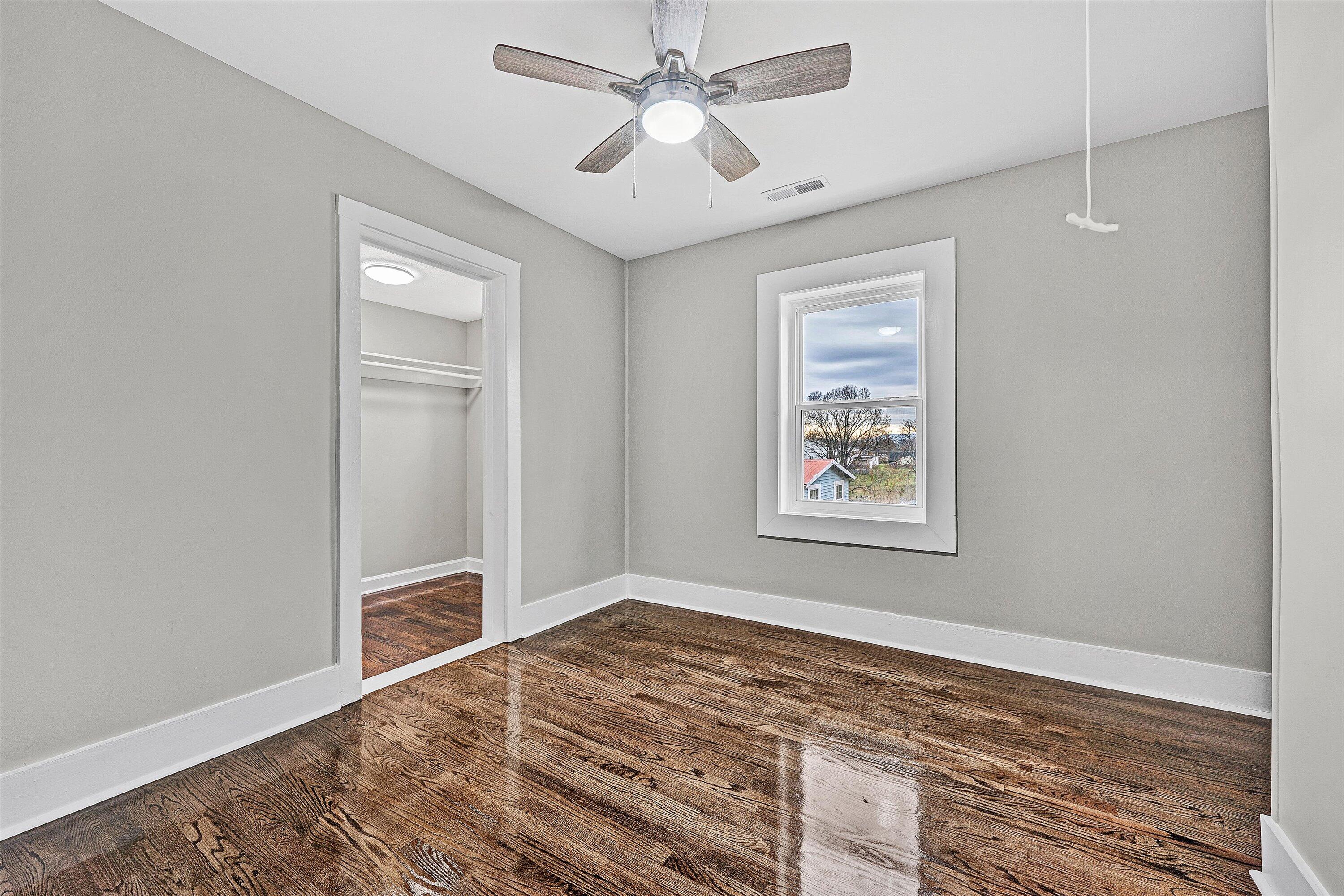 809 Ward Street Northwest Roanoke, VA 24017 - Photo 5 of 15 a view of an empty room with window and wooden floor