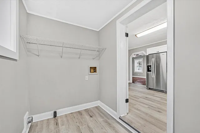 a view of a hallway with wooden floor