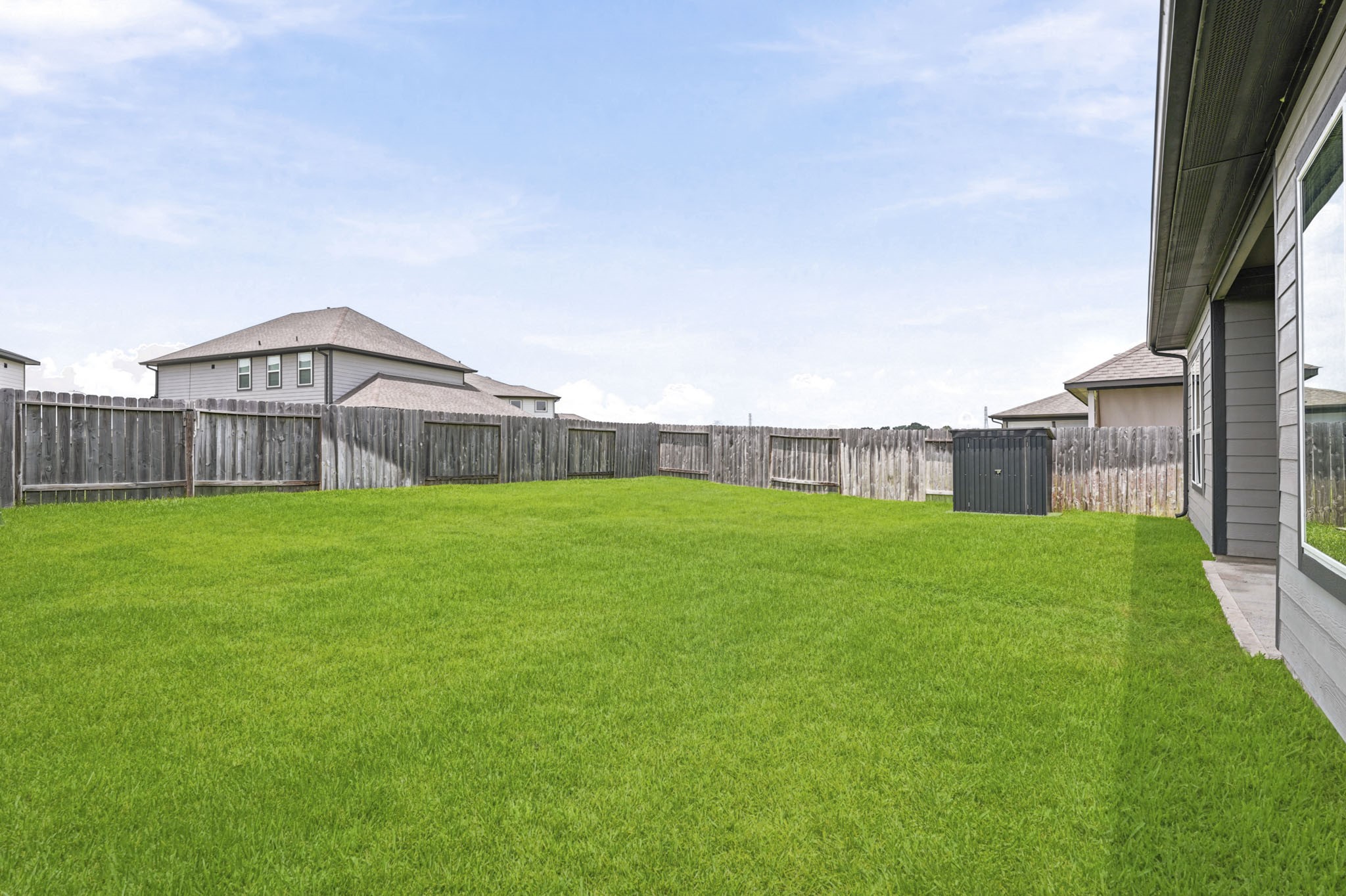 22522 Modica Rift Lane Katy, TX 77449 - Photo 34 of 38 A generous, fully fenced backyard stretches wide beneath an open Texas sky — ready for whatever you can dream up. Lush green grass, a full privacy fence, and a covered patio just off the back door create the perfect foundation for weekend cookouts, evening gatherings, pets at play, or a future outdoor oasis. The canvas is yours — and it's a good one.