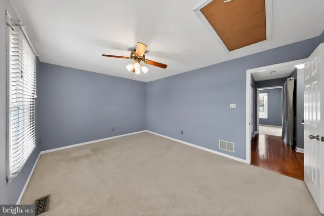 an empty room that has a painting on the wall