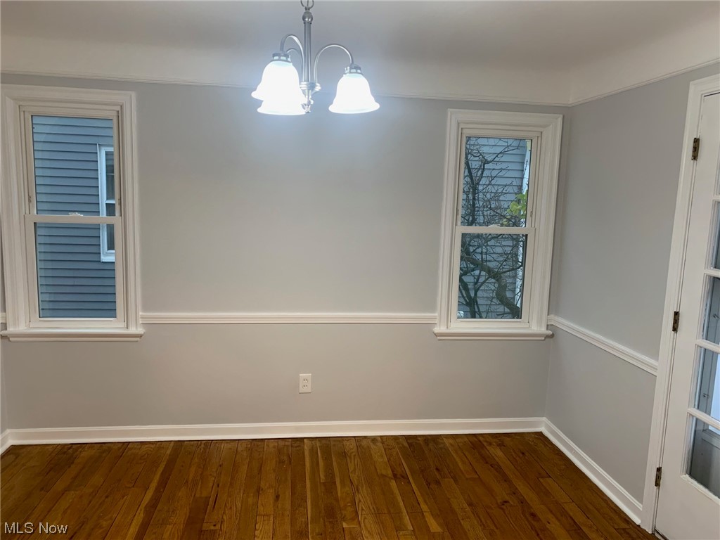 1456 Evanston Road Lyndhurst, OH 44124 - Photo 10 of 32 Spare room featuring dark hardwood / wood-style flooring and a chandelier