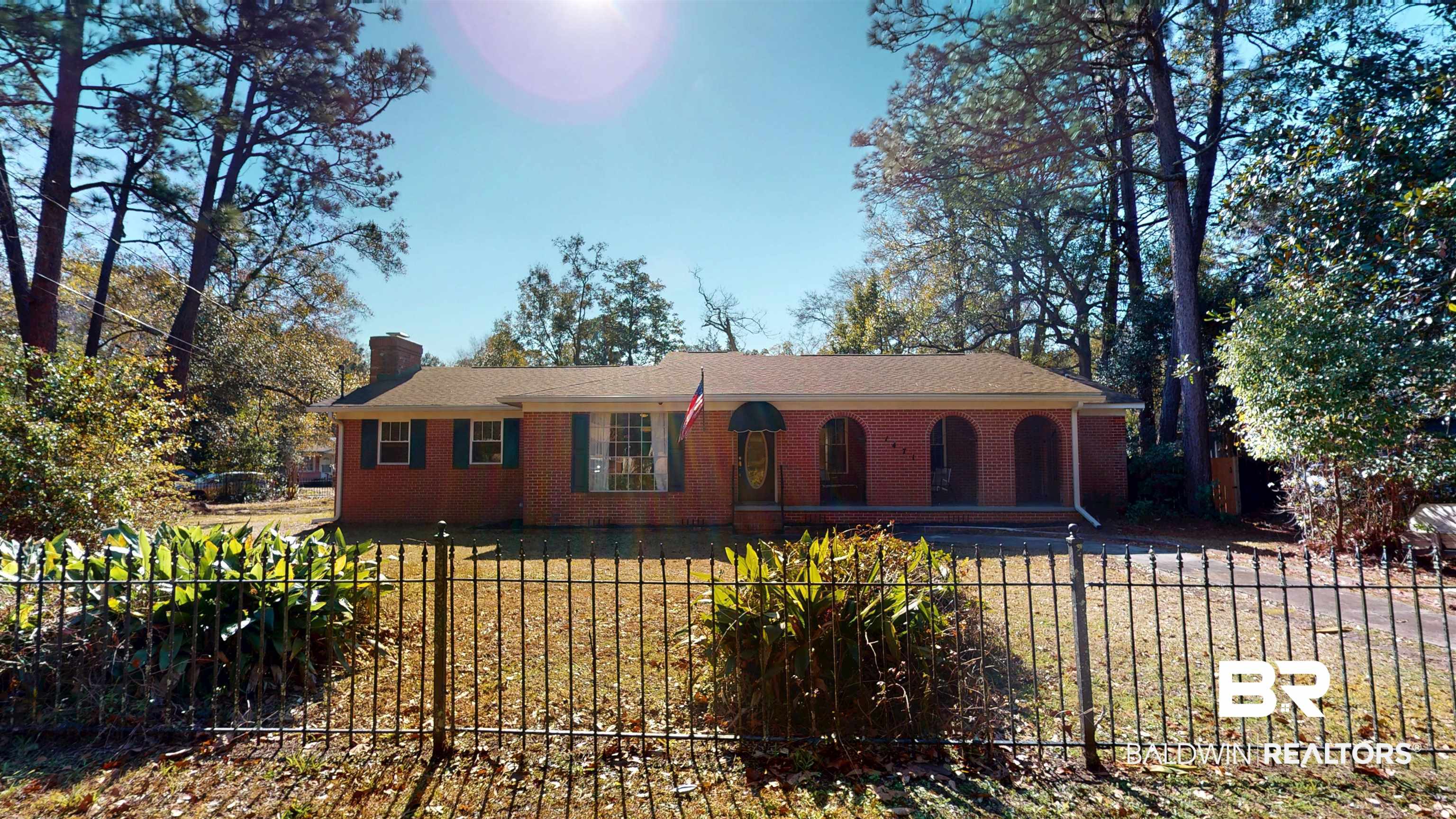 1471 Cedar Crescent Drive Mobile, AL 36605 - Photo 2 of 28 Single story home featuring a chimney, a fenced front yard, brick siding, and covered porch