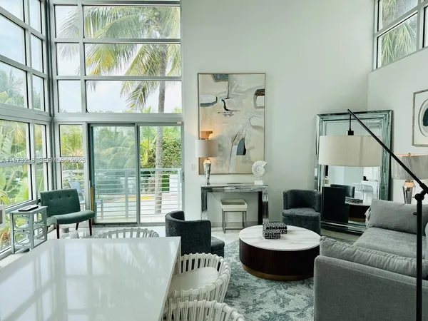 a living room with furniture and a large window