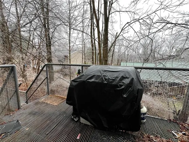 a view of a roof deck with wooden floor and fence