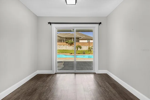 a view of an empty room and wooden floor