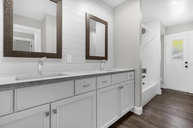 a bathroom with a double vanity sink and mirror