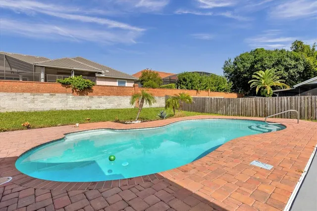 a view of a swimming pool with a yard