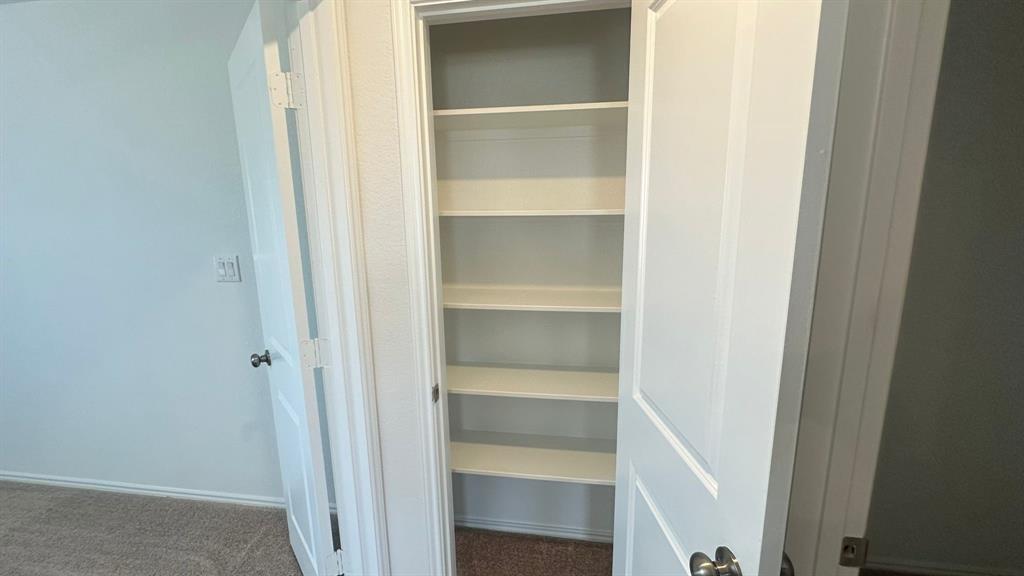 192 Rodney Boat Road Kyle, TX 78640 - Photo 31 of 38 Functional built-in shelving offers versatile storage in this well-appointed space.