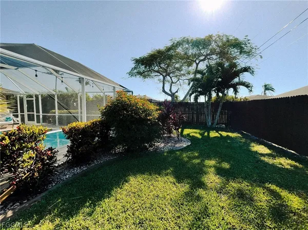 a view of a back yard of the house and front view of a house