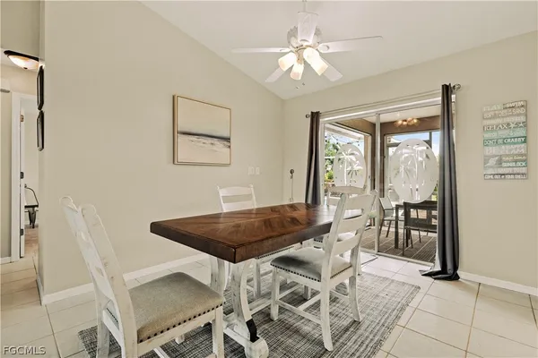 a view of a dining room with furniture and a chandelier