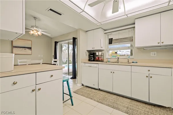 a kitchen with cabinets and window