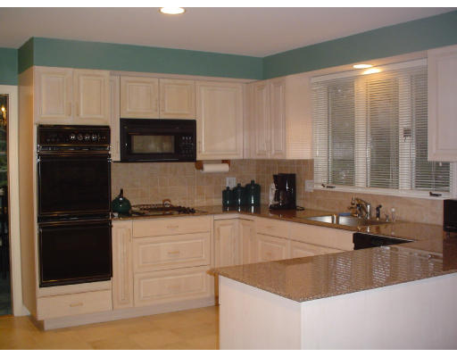 122 Kendall Road Lexington, MA 02421 - Photo 5 of 15 a kitchen with granite countertop a stove a sink and a microwave