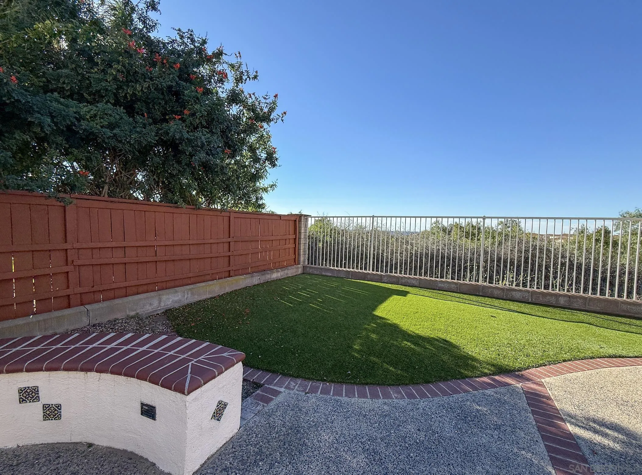 700 Rocking Horse Drive Chula Vista, CA 91914 - Photo 21 of 25 a view of a backyard with a sitting area and wooden fence