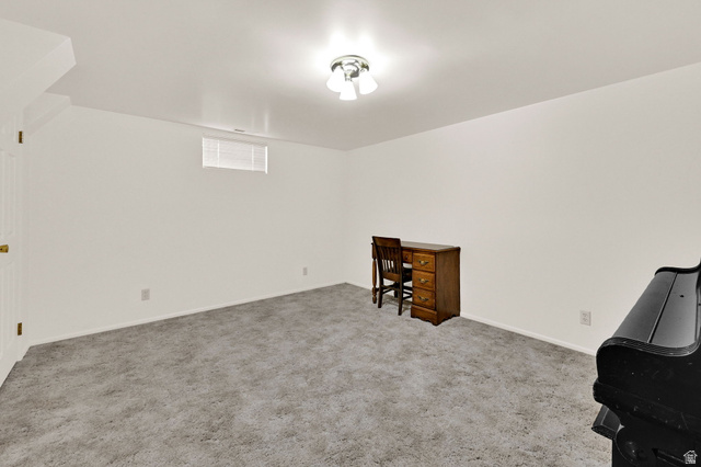 2467 South 2000 West Syracuse, UT 84075 - Photo 21 of 28 Spacious room featuring light-colored carpet flooring, white painted walls, and a semi-flush mount ceiling light fixture