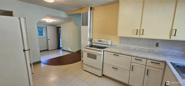 a kitchen with a sink stove and cabinets