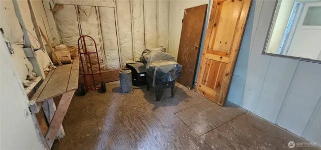 a view of a wooden house and a yard