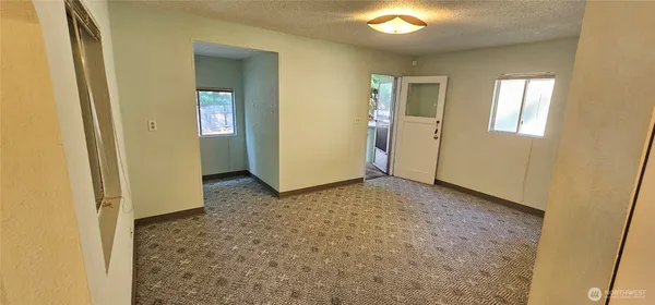 a kitchen with a refrigerator a stove top oven and cabinets