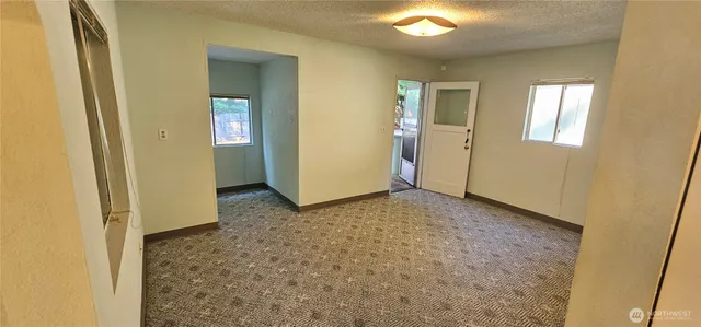 a kitchen with a refrigerator a stove top oven and cabinets