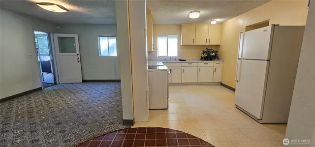 a kitchen with a refrigerator sink stove and cabinets