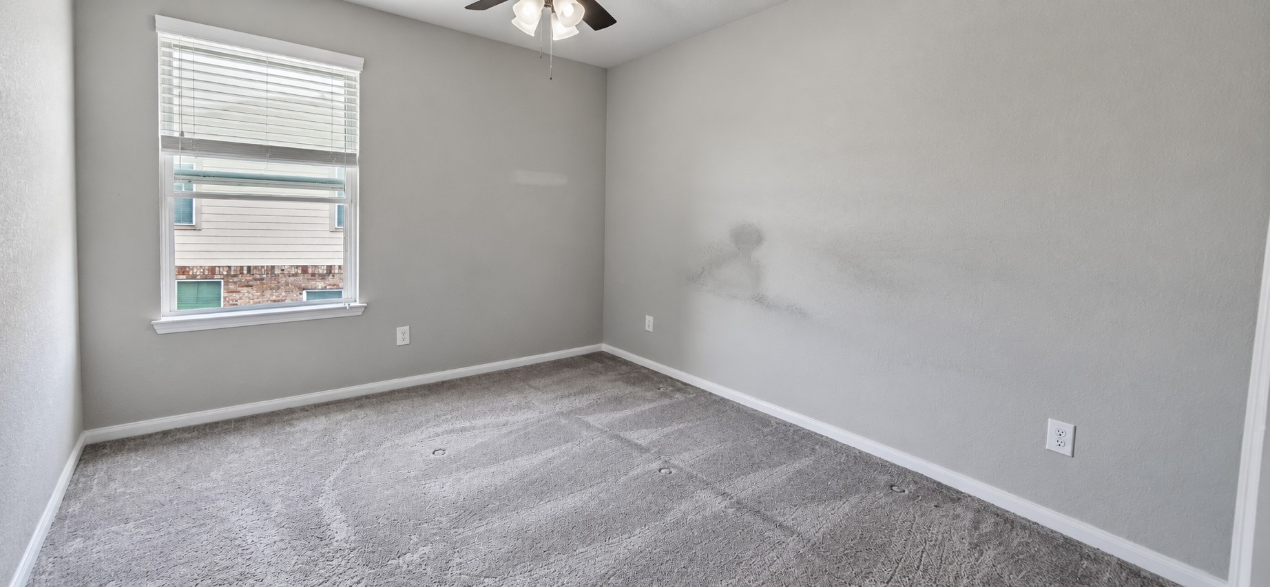 11355 Cascading Stream Way Houston, TX 77044 - Photo 14 of 17 Bright bedroom with soft gray walls, cozy carpeting, and a ceiling fan, featuring a window for natural light.