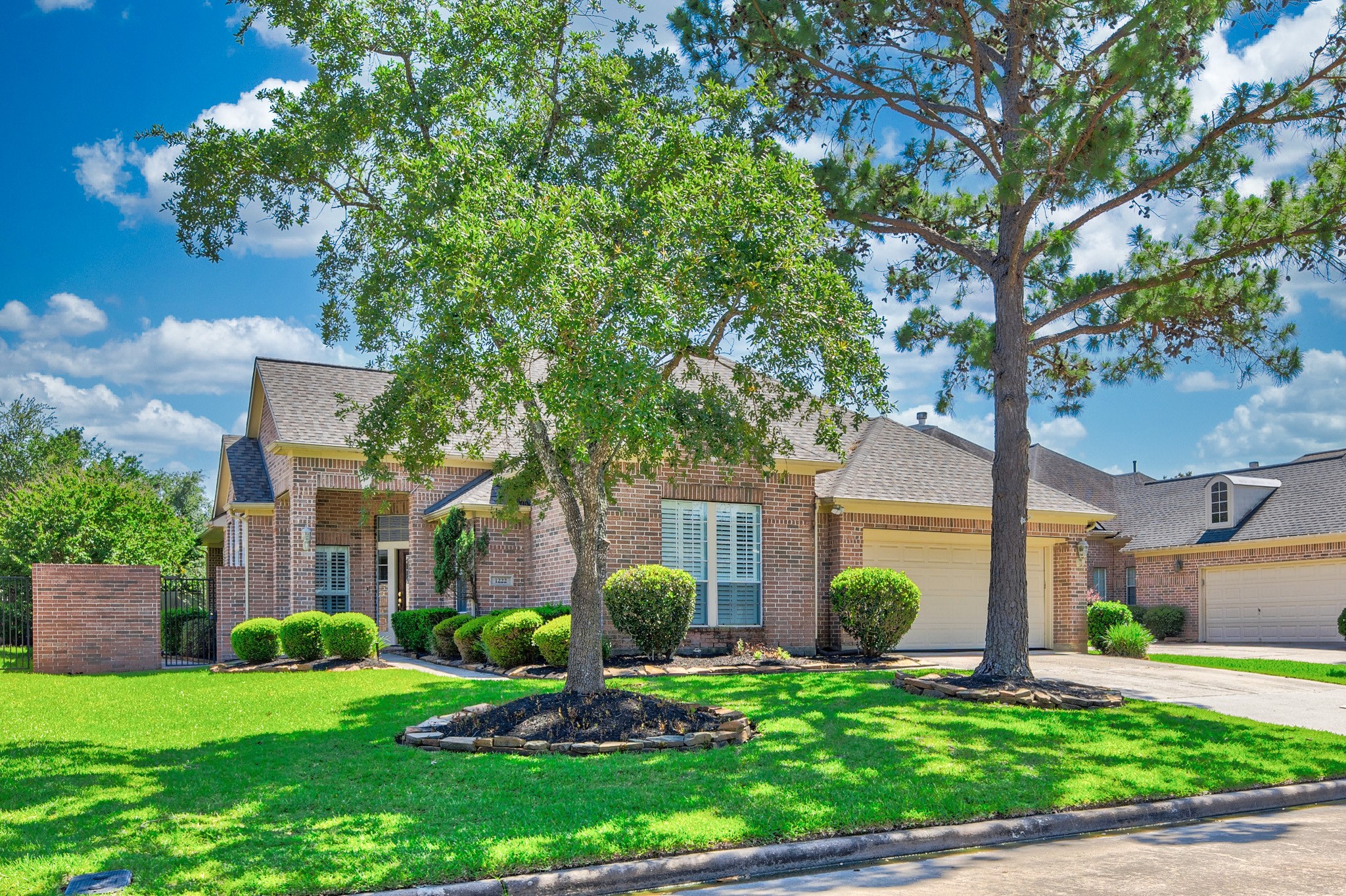 1222 Brinson Court Spring, TX 77379 - Photo 2 of 35 a front view of a house with garden and trees