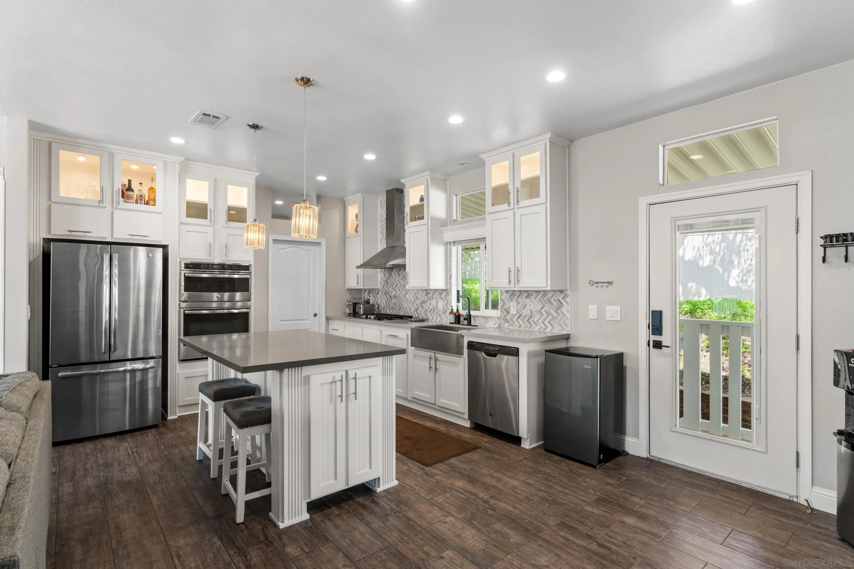 a kitchen with stainless steel appliances granite countertop a refrigerator and a stove top oven
