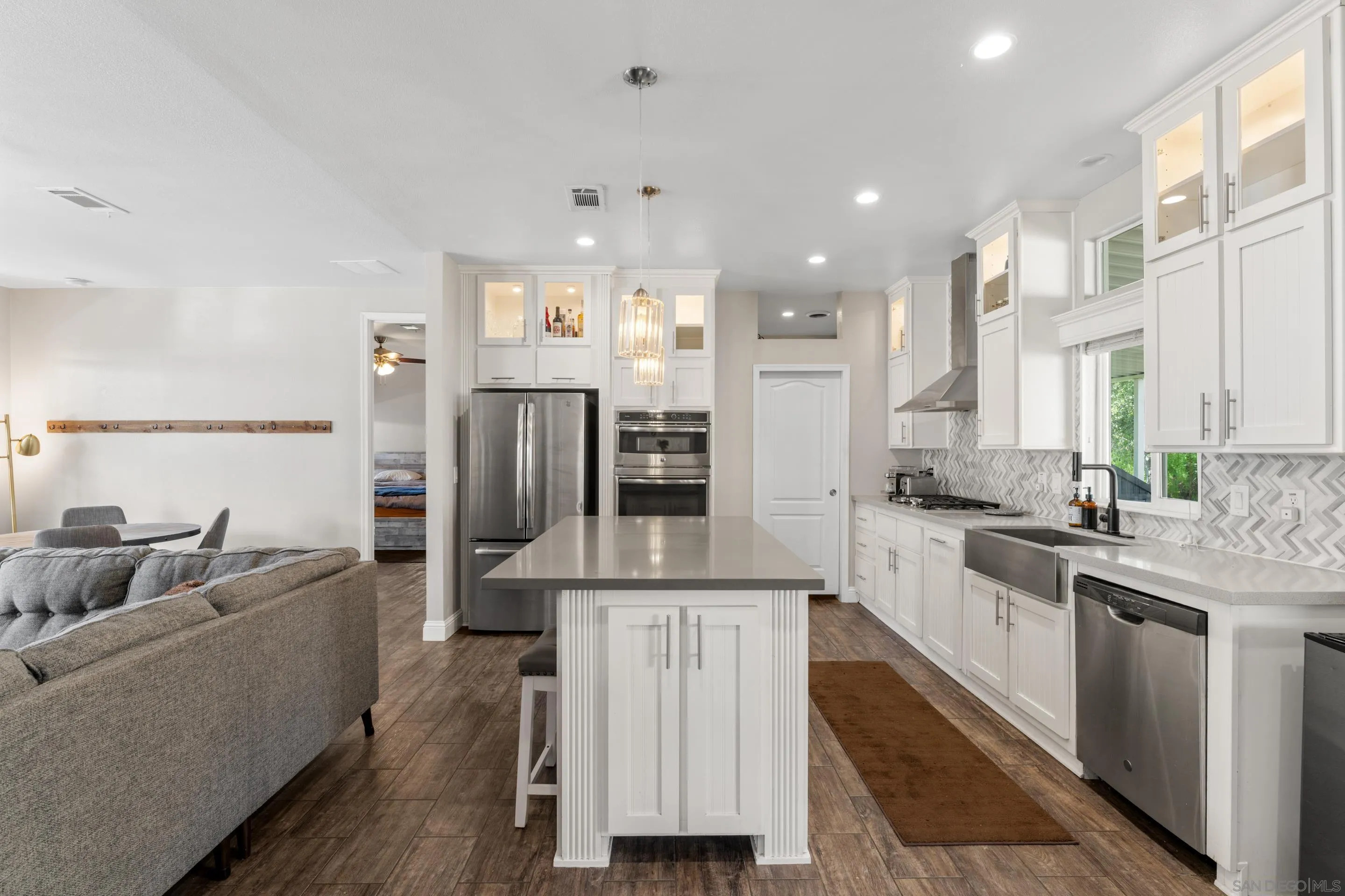 3505 Alpine Boulevard, Unit 1 Alpine, CA 91901 - Photo 11 of 27 a large kitchen with stainless steel appliances kitchen island granite countertop a refrigerator and a stove top oven