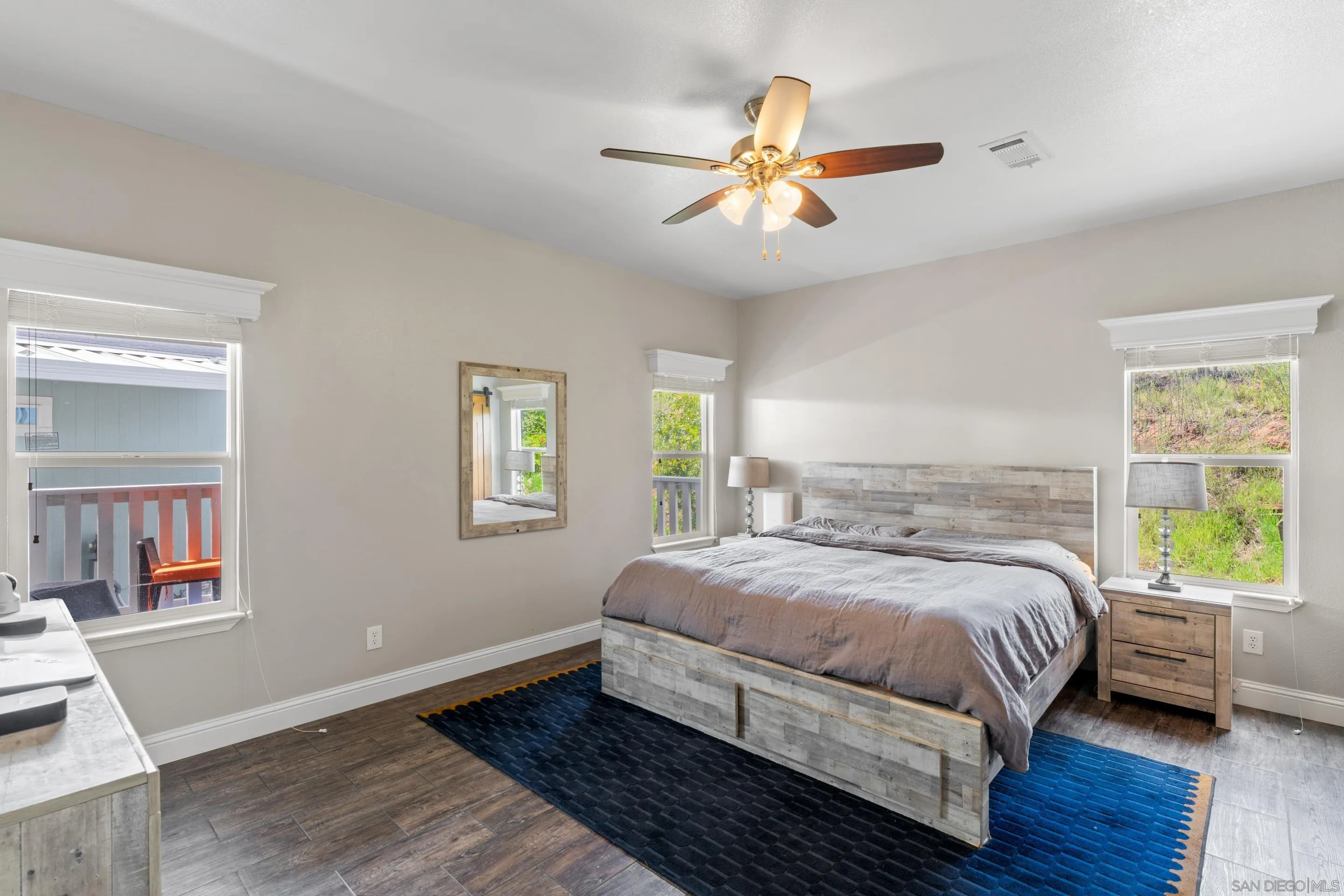 3505 Alpine Boulevard, Unit 1 Alpine, CA 91901 - Photo 12 of 27 a bedroom with a bed and wooden floor