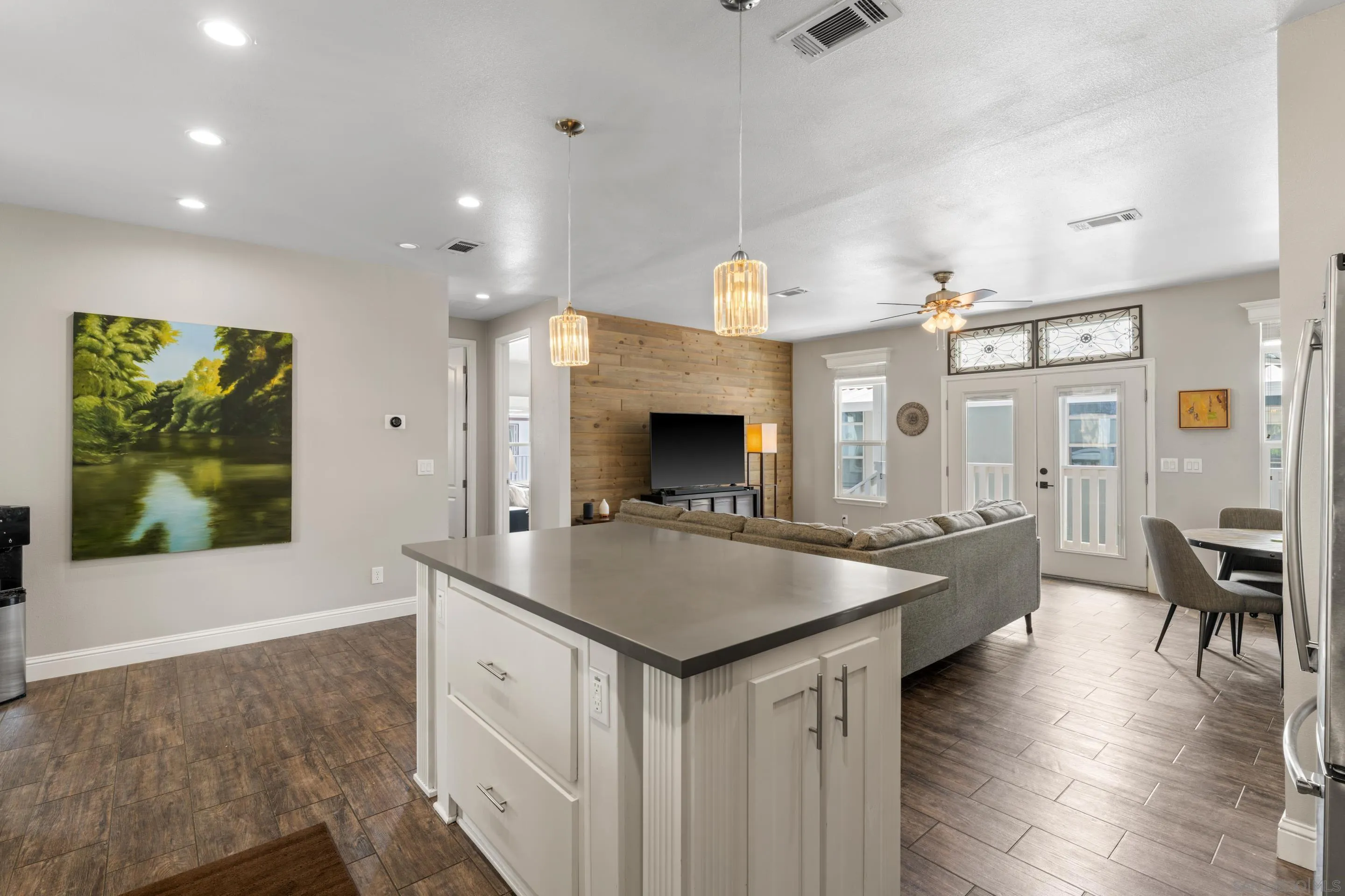 3505 Alpine Boulevard, Unit 1 Alpine, CA 91901 - Photo 15 of 27 a living room with stainless steel appliances kitchen island a table and chairs in it