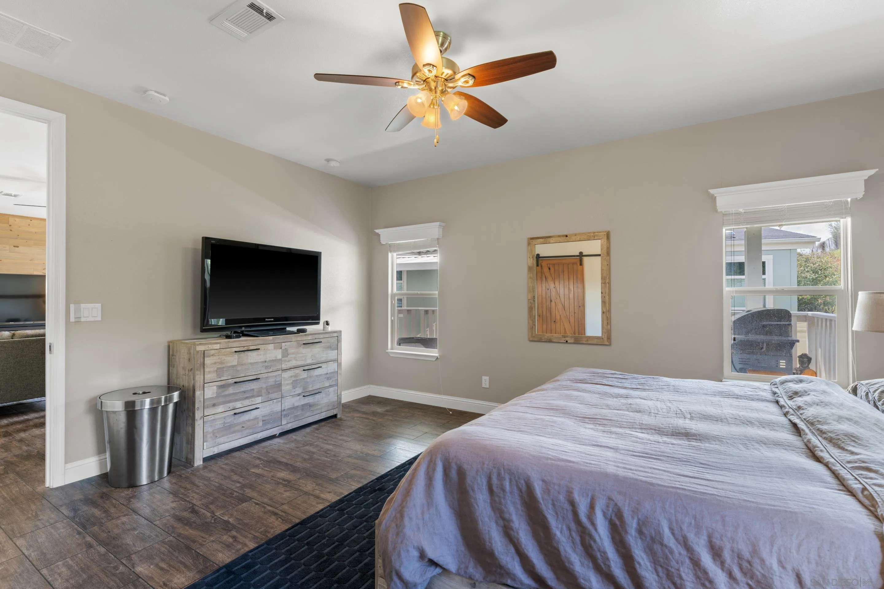 3505 Alpine Boulevard, Unit 1 Alpine, CA 91901 - Photo 18 of 27 a bedroom with a bed and a flat screen tv