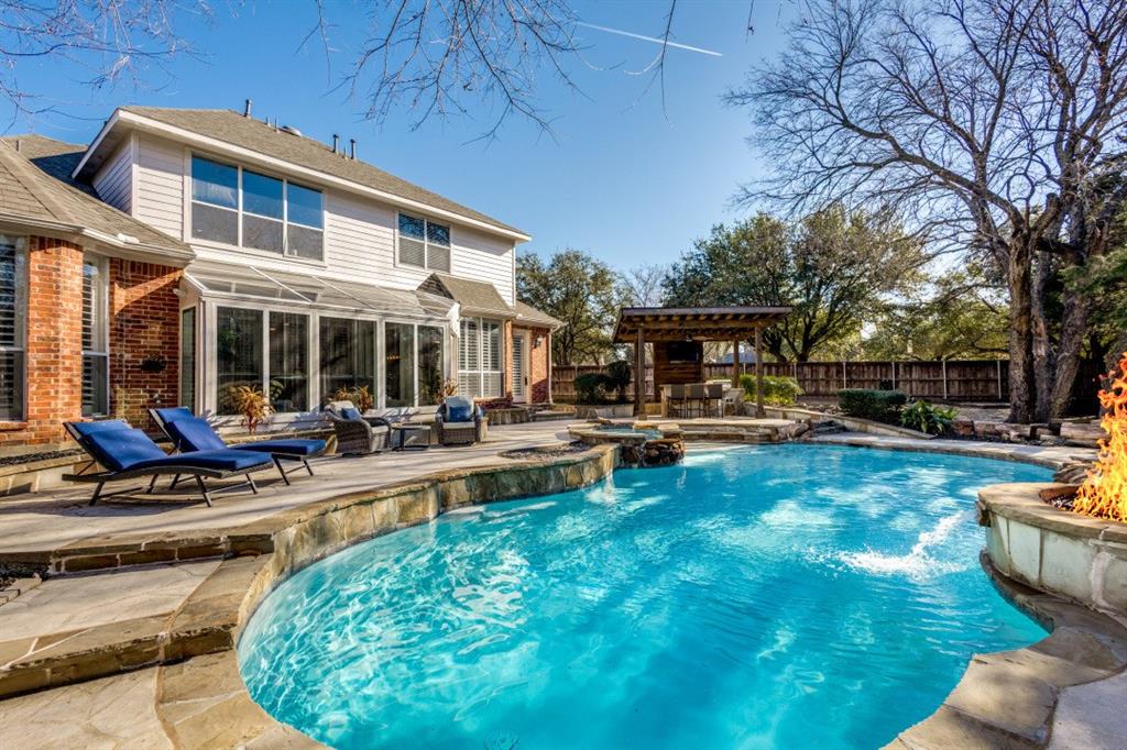 a view of a house with swimming pool and sitting area