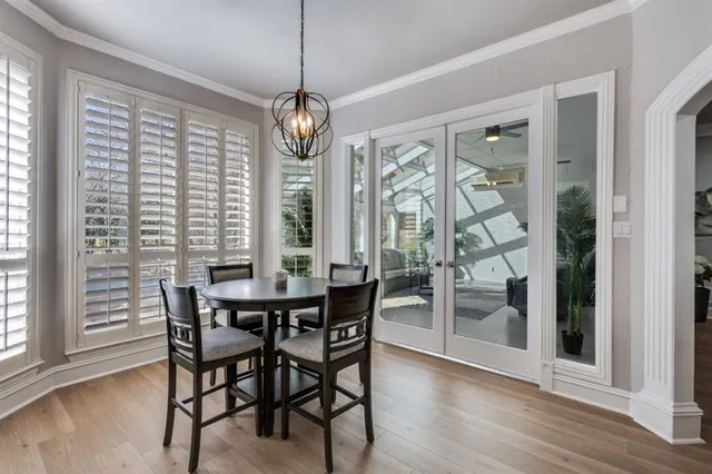 a view of a dining room with furniture wooden floor and chandelier