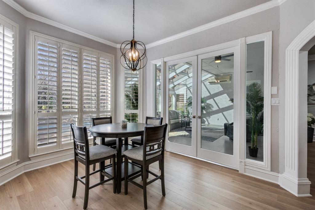 3512 Provine Road McKinney, TX 75072 - Photo 16 of 33 a view of a dining room with furniture wooden floor and chandelier