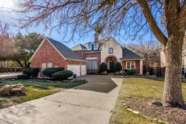 a front view of a house with yard and garage