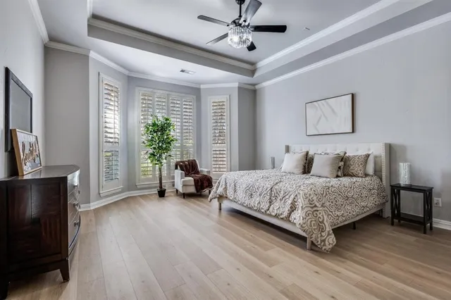 a spacious bedroom with a bed a couch and a large window