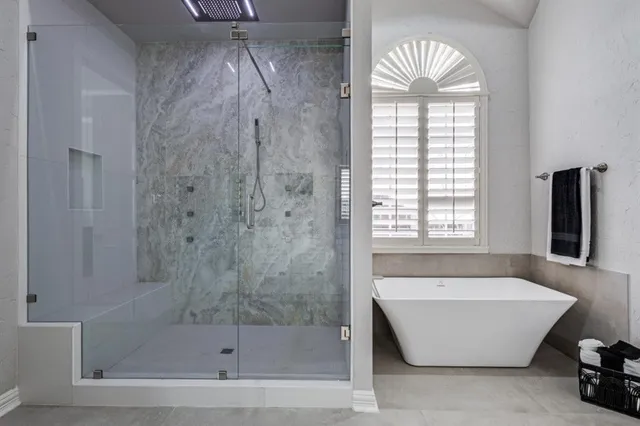 a bathroom with a bathtub and a shower
