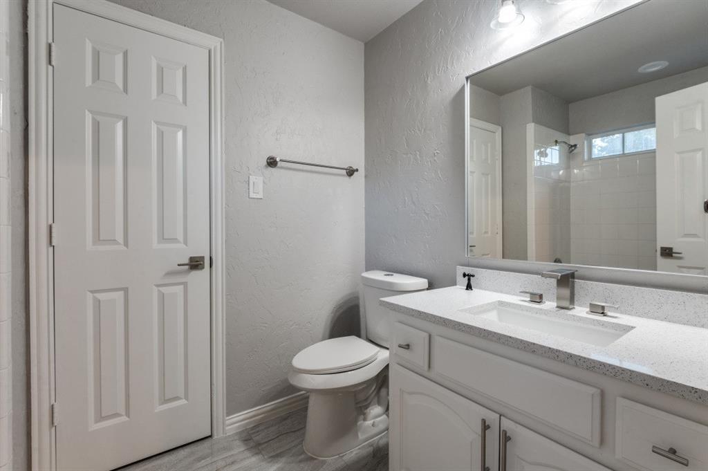 3512 Provine Road McKinney, TX 75072 - Photo 29 of 33 a bathroom with a toilet a sink and mirror