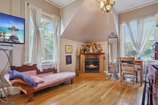 a bedroom with furniture and a fireplace