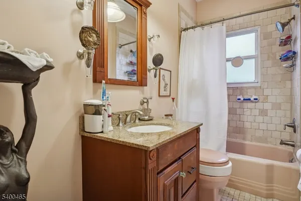 a bathroom with a sink toilet vanity and shower