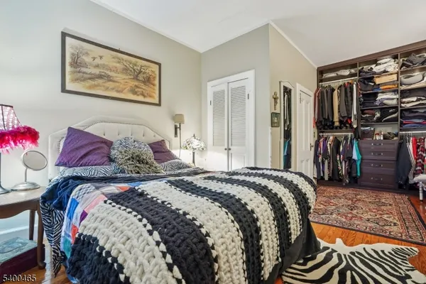 a bedroom with a bed and a view of walk in closet
