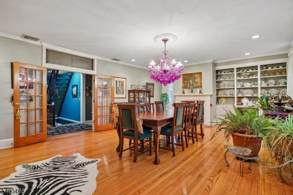 a dining room with furniture a chandelier and wooden floor