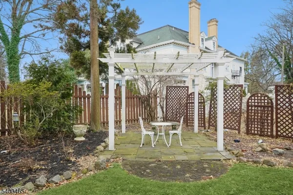 a view of a chairs and table in backyard
