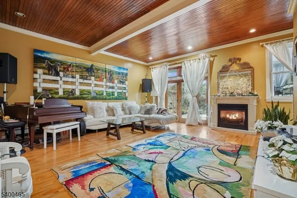 a living room with furniture fireplace and a large window