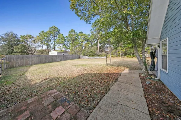 a view of a backyard of the house