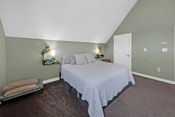 a bedroom with a bed and a chair