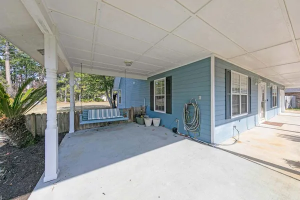 a view of a house with porch and garden