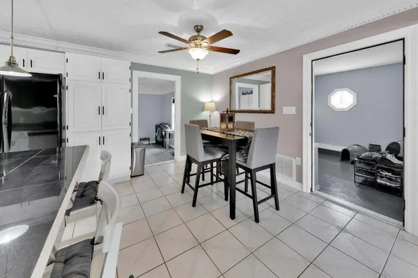 a living room with furniture a flat screen tv and a table
